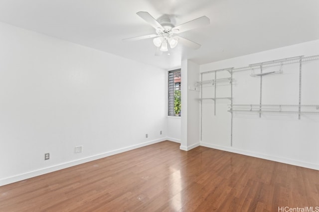 spare room with ceiling fan and wood-type flooring