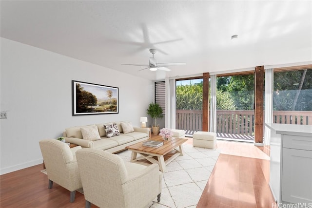 living room with light hardwood / wood-style floors and ceiling fan