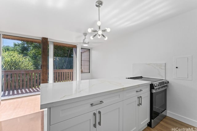 kitchen with light stone counters, pendant lighting, wood-type flooring, white cabinets, and stainless steel range with electric cooktop