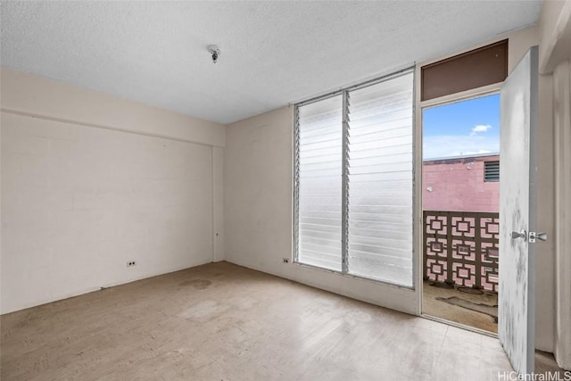 spare room with a textured ceiling