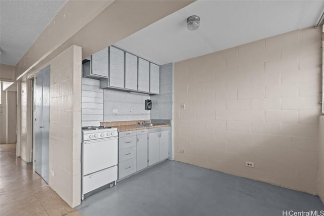 kitchen with white range with gas cooktop and sink