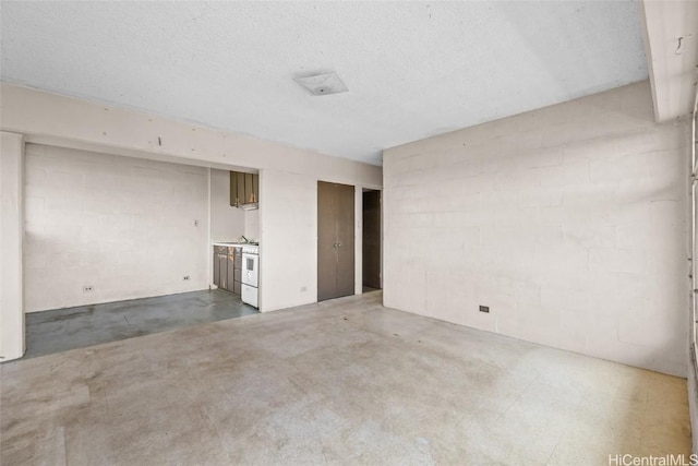 unfurnished living room with concrete flooring and a textured ceiling