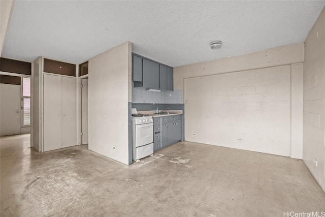 kitchen featuring gray cabinets, sink, decorative backsplash, white gas stove, and a textured ceiling