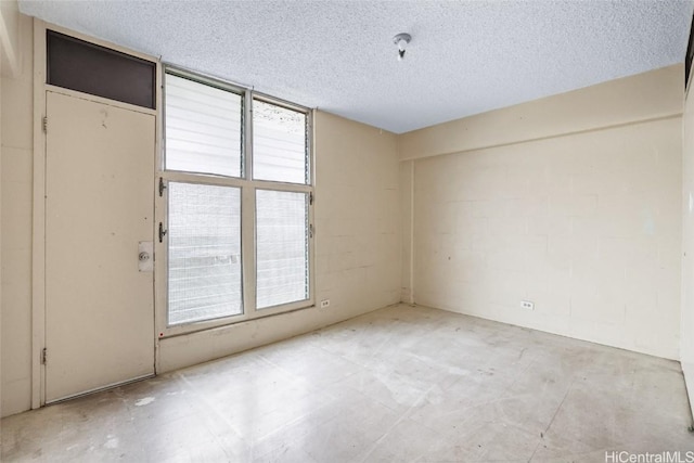 spare room featuring a textured ceiling