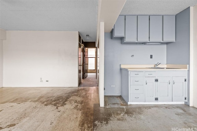 kitchen with sink and a textured ceiling