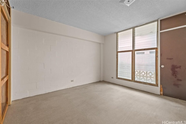 unfurnished room featuring a textured ceiling