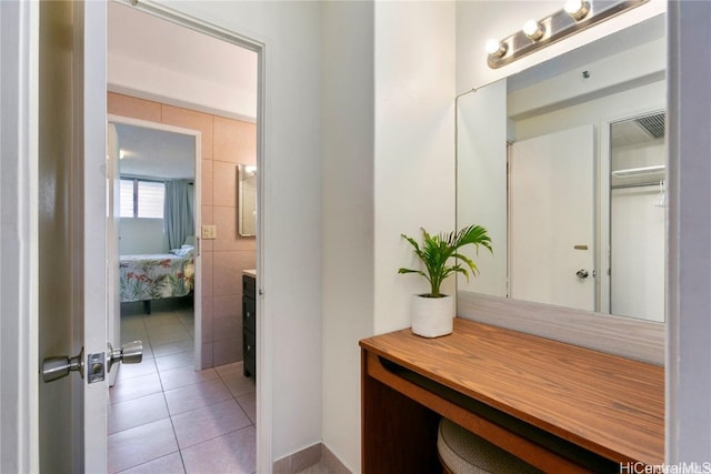 interior space with tile walls and light tile patterned floors