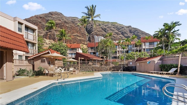 view of swimming pool featuring a mountain view and a patio