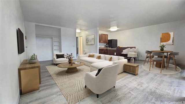 living room with light hardwood / wood-style flooring and built in features