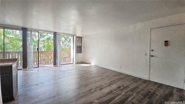 unfurnished living room with hardwood / wood-style floors and expansive windows