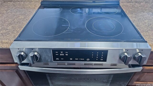 details with blue cabinets and stainless steel stove