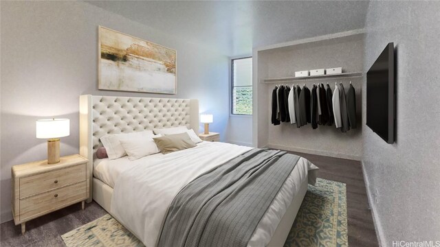 bedroom with dark hardwood / wood-style flooring and a closet