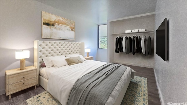 bedroom with dark wood-style flooring and a closet