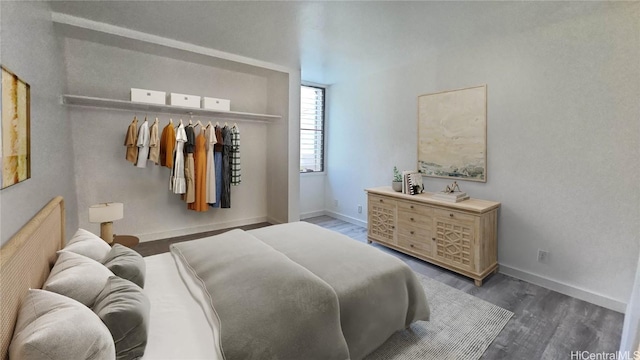 bedroom with dark wood-style flooring and baseboards