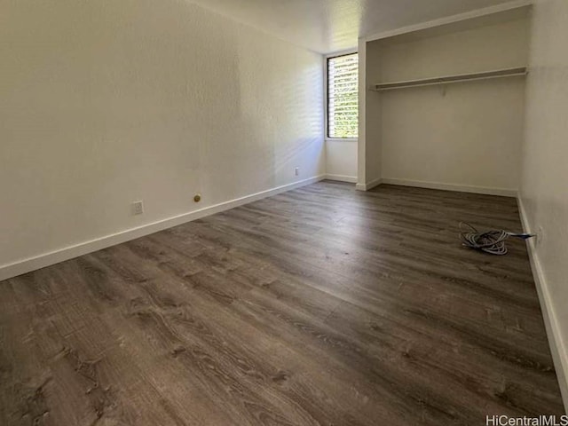 unfurnished bedroom featuring dark wood finished floors and baseboards