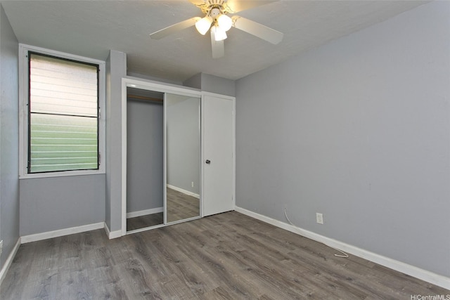 84-664 Ala Mahiku St Unit 196C, Waianae, HI 96792 - unfurnished bedroom featuring a closet, a ceiling fan, wood finished floors, and baseboards