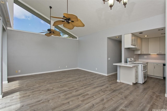84-664 Ala Mahiku St Unit 196C, Waianae, HI 96792 - kitchen featuring wood finished floors, double oven range, light countertops, ceiling fan with notable chandelier, and baseboards