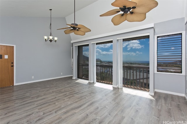 spare room with ceiling fan, wood-type flooring, and high vaulted ceiling