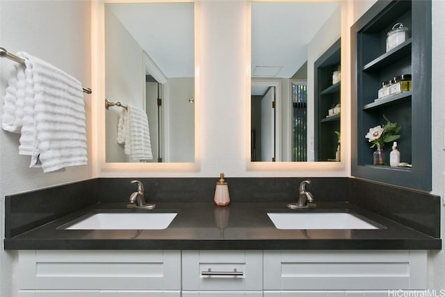 full bath with a sink and double vanity