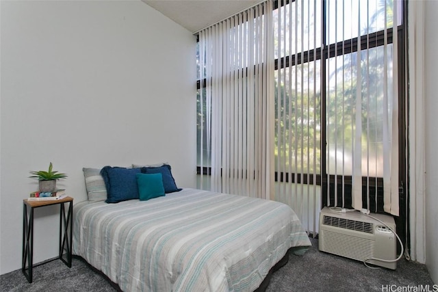 carpeted bedroom with a wall mounted AC