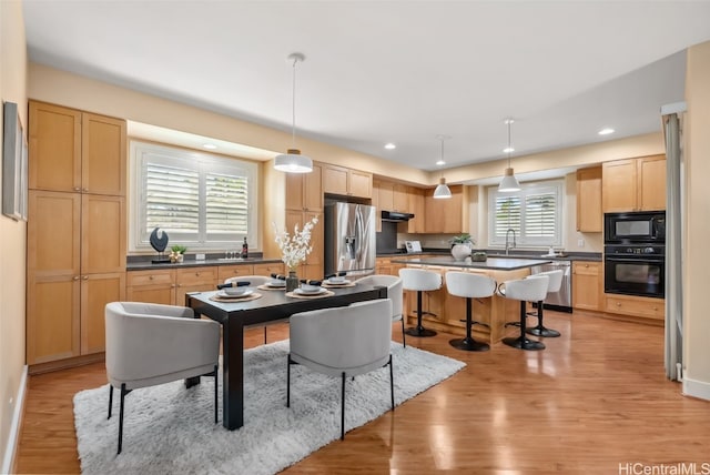 dining room featuring light hardwood / wood-style flooring and sink