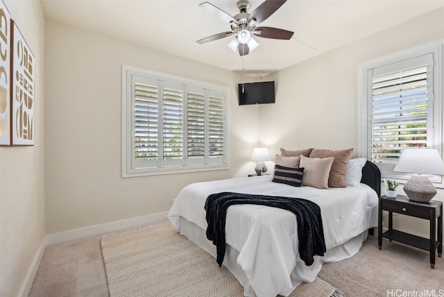 bedroom with ceiling fan and light carpet