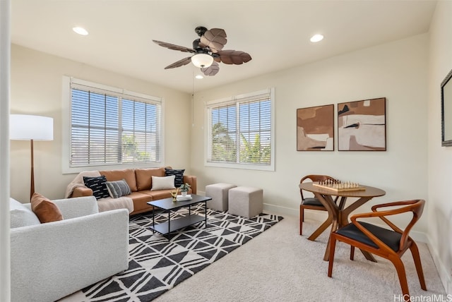 carpeted living room with ceiling fan