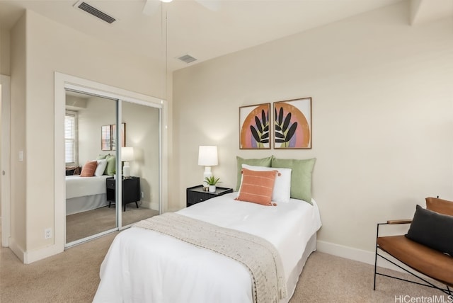 carpeted bedroom with ceiling fan and a closet