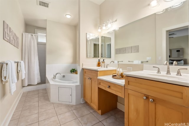 bathroom featuring tile patterned flooring, vanity, and a relaxing tiled tub