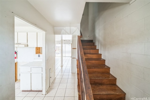 stairs featuring tile patterned floors