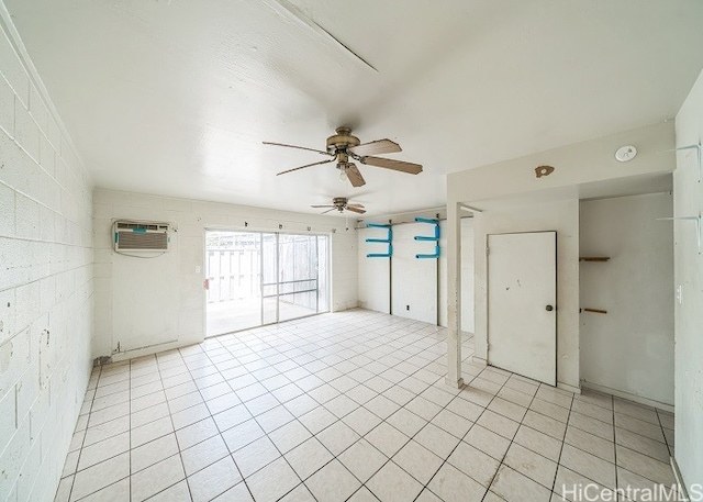 tiled empty room with ceiling fan and a wall unit AC