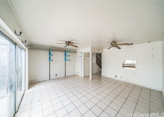 tiled spare room with ceiling fan