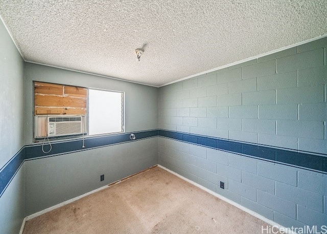 spare room featuring a textured ceiling, cooling unit, and light colored carpet