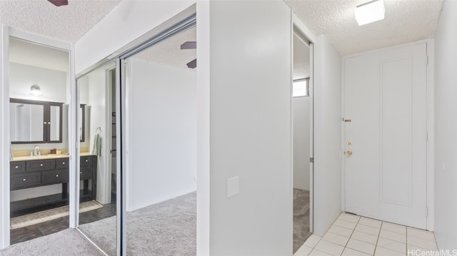 bathroom with vanity, tile patterned floors, and a textured ceiling