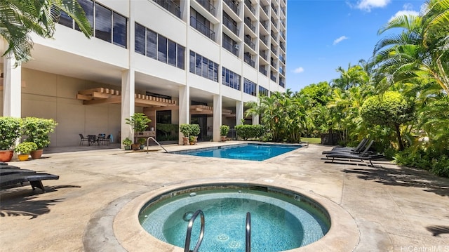 view of pool featuring a patio area and a community hot tub