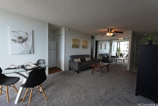 carpeted living room featuring a textured ceiling and ceiling fan