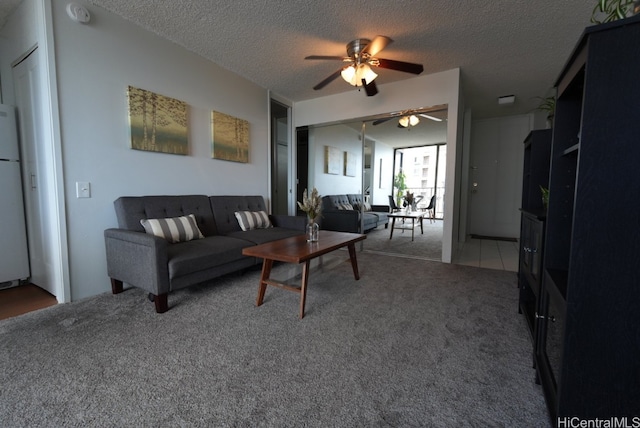 carpeted living room with a textured ceiling and ceiling fan