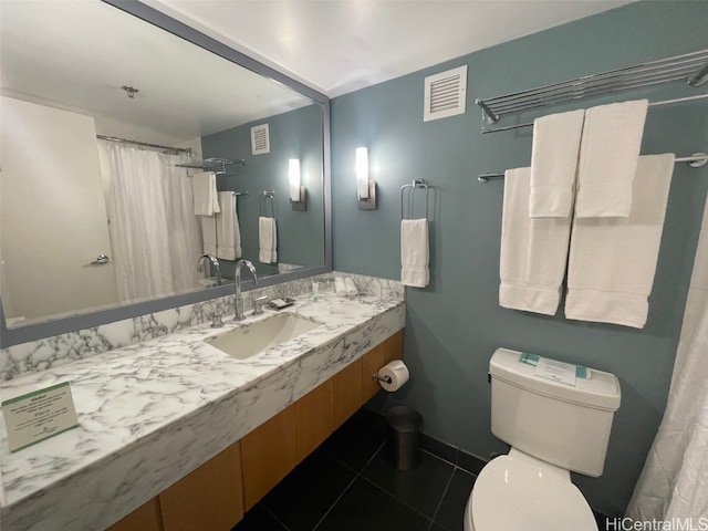 bathroom with tile patterned flooring, toilet, and sink