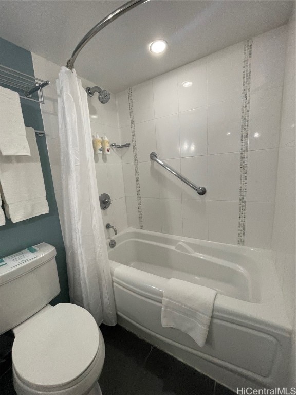 bathroom featuring tile patterned flooring, toilet, and shower / bath combo with shower curtain