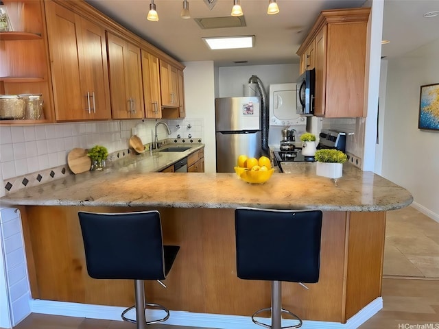 700 Richards St Unit 907, Honolulu, HI 96813 - kitchen with backsplash, a sink, stove, and freestanding refrigerator