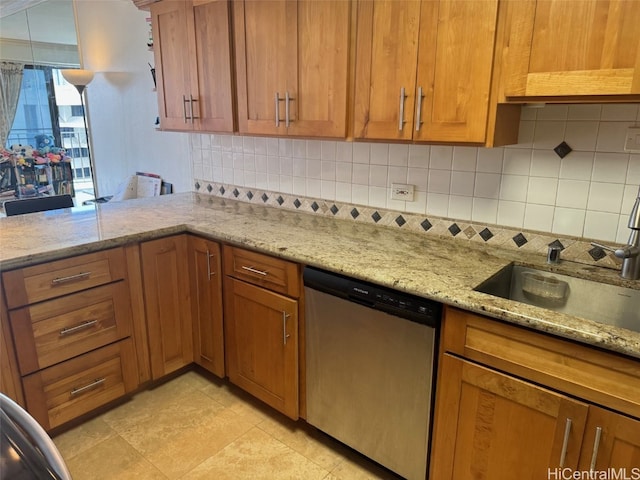 kitchen with a sink, brown cabinetry, decorative backsplash, light stone countertops, and dishwasher