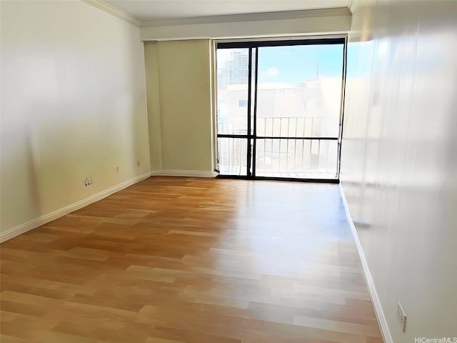 700 Richards St Unit 907, Honolulu, HI 96813 - unfurnished room featuring baseboards, ornamental molding, and light wood-type flooring