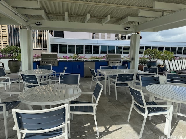 view of patio with outdoor dining area and a grill