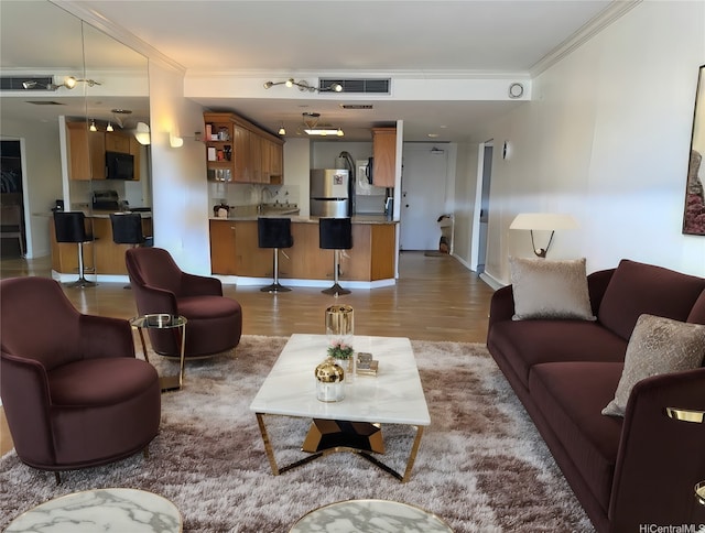 700 Richards St Unit 907, Honolulu, HI 96813 - living area with baseboards, ornamental molding, and light wood-type flooring
