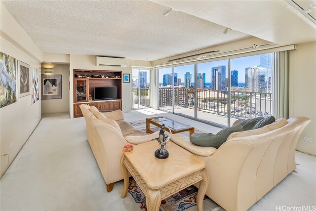 living room with a textured ceiling, a wall mounted AC, and light colored carpet