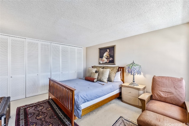 carpeted bedroom featuring a closet and a textured ceiling