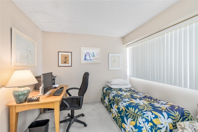 carpeted bedroom featuring a textured ceiling