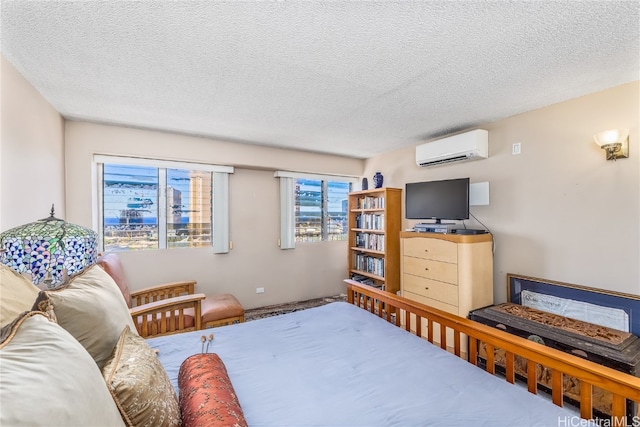 bedroom featuring a textured ceiling and a wall unit AC