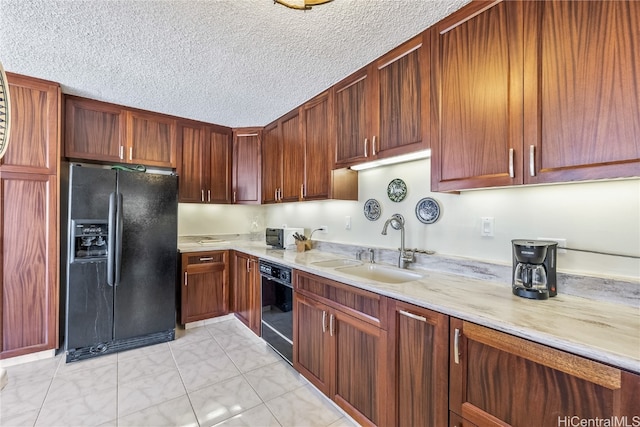 kitchen with sink, black appliances, and a textured ceiling