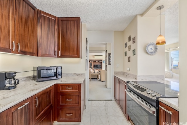 kitchen featuring light stone countertops, a textured ceiling, appliances with stainless steel finishes, and pendant lighting